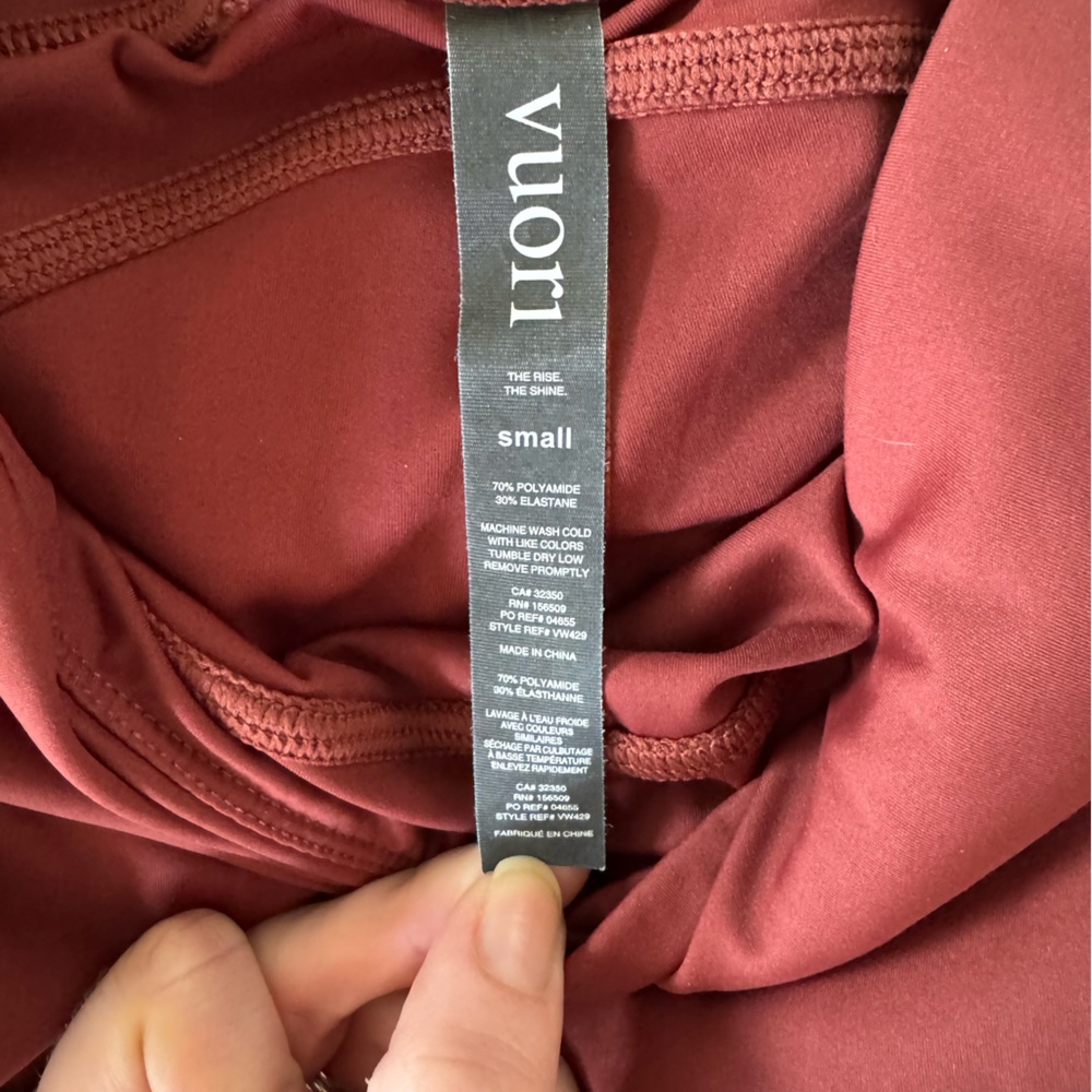 Rust colored Vuori ankle-length leggings. Worn only once. Size small.